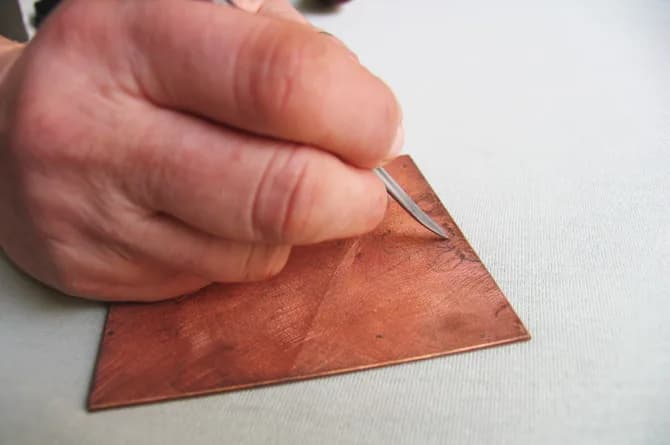 The same moment from slightly above, the tool tip just visible under the fingers.
